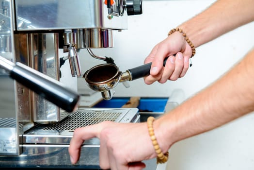 man using espresso metallic machine with portafilter