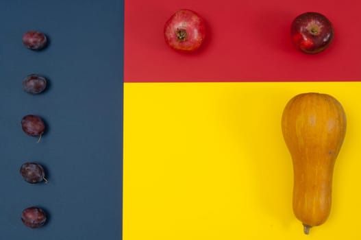 Organic autumn fruits and nuts isolated on split background with copy space