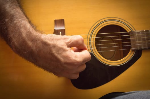 Practicing in playing guitar. The old men playing guitar