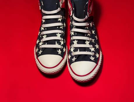 Dnipropetrovsk, Ukraine - May, 29 2016: All Star Converse sneakers on red background