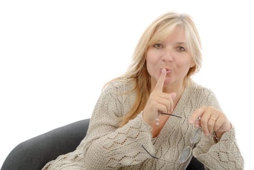 beautiful blond mature woman put a finger to her lips