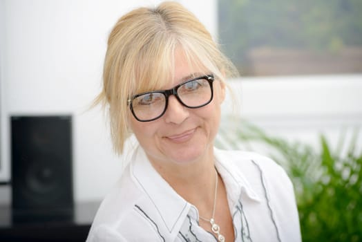 a portrait of mature smiling blond woman