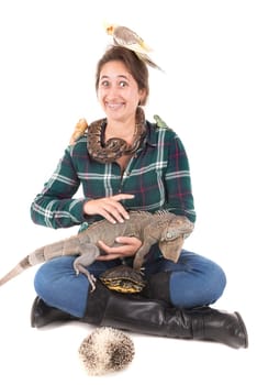 Girl with several pet animals isolated in white
