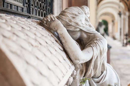 More than 100 years old statue. Cemetery located in North Italy.