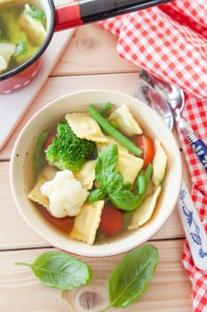 Rustic soup with fresh colorful vegetables