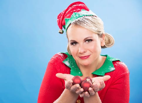 blonde woman wearing elf christmas costume on blue background