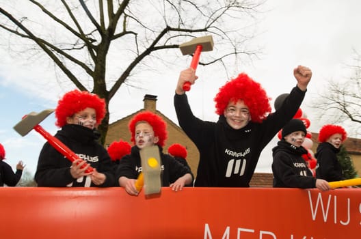 OLDENZAAL, NETHERLANDS - FEBRUARY 7, 2016: Unknown people joining the annual carnival parade with a decorated wagon