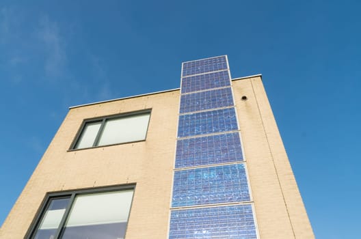 modern house in the netherlands with a row of solar panels at the its facade