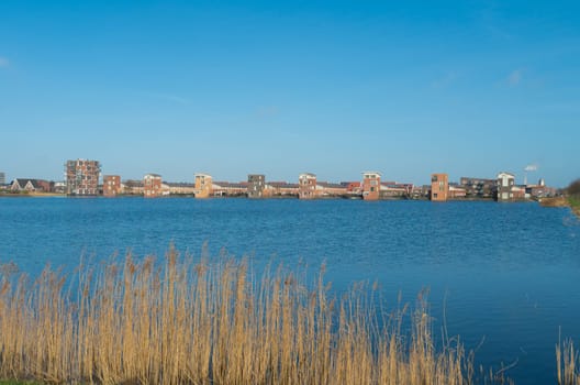 lakeside view of a newly build residential area in the netherlands