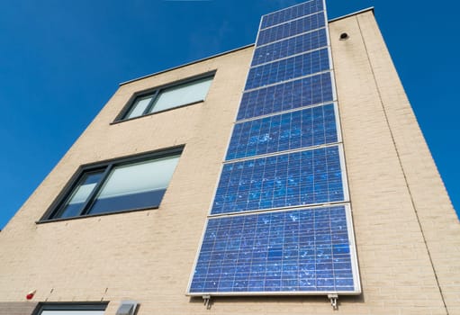 modern house in the netherlands with a row of solar panels at the its facade
