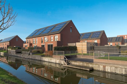 modern terraced houses with solar panels in a newly build residential area in the netherlands