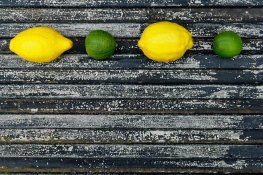 Raw textured black Background backdrop with lemon and lime and copy space outdoor