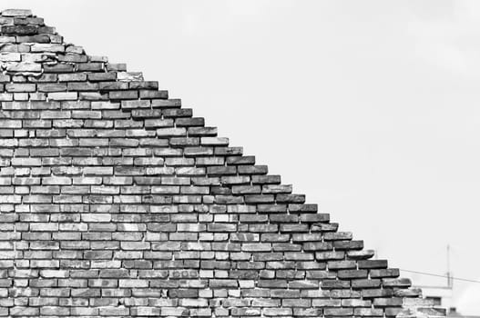 Textured old diagonal brick wall background,monochrome