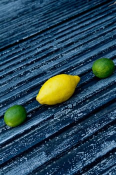 Raw textured black Background backdrop with lemon and lime and copy space outdoor