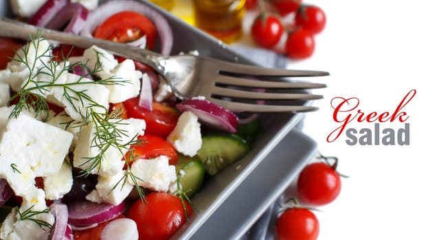 Greek salad with tomatoes, feta cheese, cucumbers, onions and olives