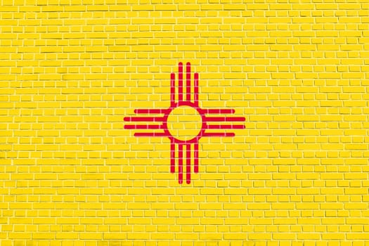 New Mexican official flag, symbol. American patriotic element. USA banner. United States of America background. Flag of the US state of New Mexico on brick wall texture background