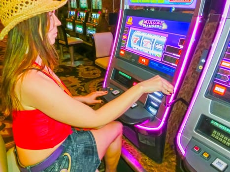 Las Vegas, United States of America - May 05, 2016: Concentrated girl playing slot machines in the Excalibur Hotel and Casino