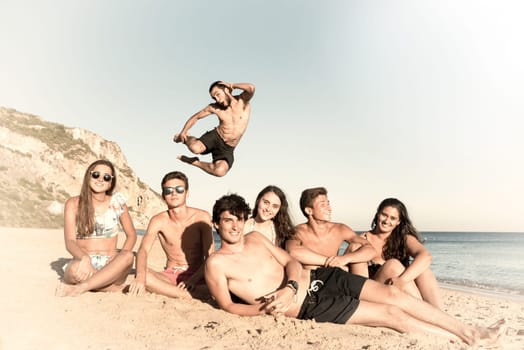 Group of happy teenage friends having fun at the beach