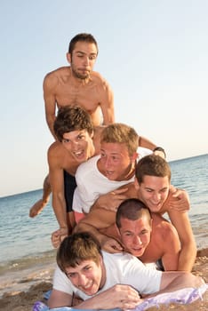 Group of happy teenage boys at the beach