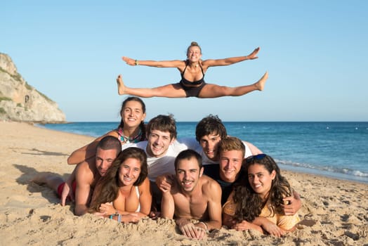 Group of happy teenage friends having fun at the beach