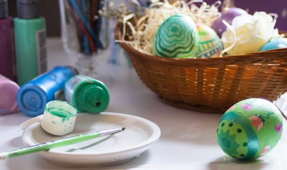 Preparing for Easter, painting eggs with your own hands. Horizontal real picture. Home decorating scene getting ready for Easter. Easter decoration concept