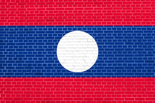 Laotian national official flag. Patriotic symbol, banner, element, background. Flag of Laos on brick wall texture background