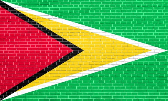 Guyanan national official flag. Patriotic symbol, banner, element, background. Flag of Guyana on brick wall texture background