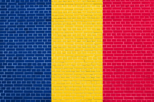 Chadian national official flag. African patriotic symbol, banner, element, background. Flag of Chad on brick wall texture background