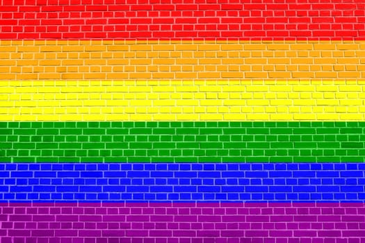 Rainbow gay pride flag. Symbol of LGBT movement. Gay banner, element, background. Rainbow flag on brick wall texture background