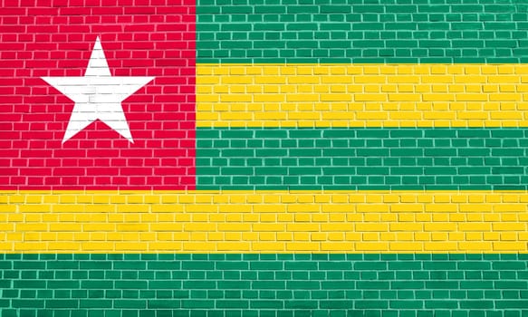 Togolese national official flag. African patriotic symbol, banner, element, background. Flag of Togo on brick wall texture background