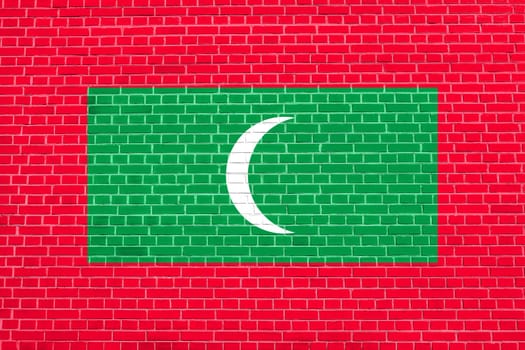 Maldivian national symbol. Patriotic background design. Flag of Maldives on brick wall texture background