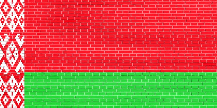 Belarusian national official flag. Patriotic symbol, banner, element, background. Flag of Belarus on brick wall texture background