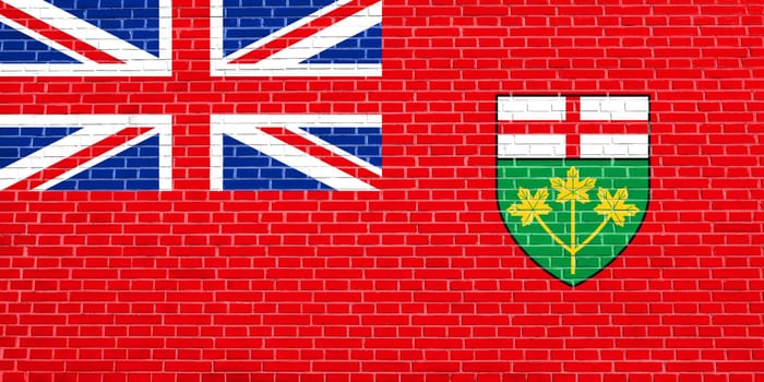 Ontarian provincial flag, patriotic element and official symbol. Canada banner and background. Flag of the Canadian province of Ontario on brick wall texture background