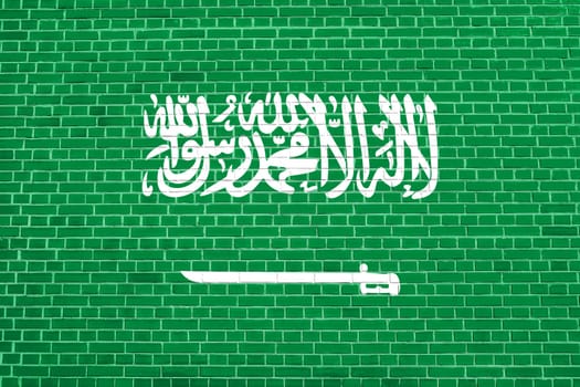 Saudi Arabian national official flag. Patriotic symbol, banner, element, background. Flag of Saudi Arabia on brick wall texture background
