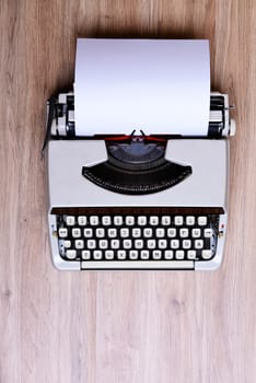 old typewriter on wooden ground from above