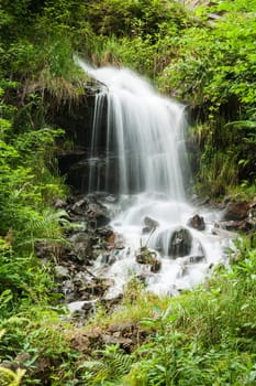 Long-term exposure of a small waterfall in the South Tyrolean Alps above the city of Merano in summer.