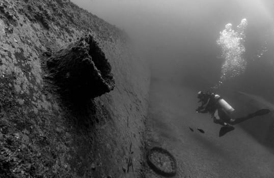 A diver in front of a sunken ship in the waters outside Cape Verde