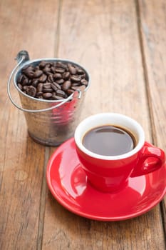 Red cup of espresso on wooden table, stock photo