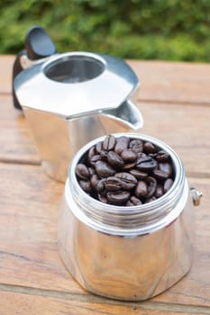 Roasted coffee beans in moka pot, stock photo