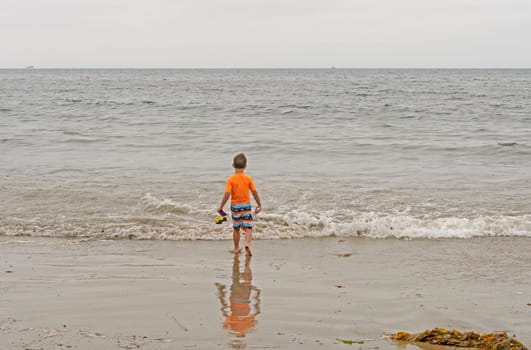 Boy Heading Out to the Ocean on Burro Arroyo Beach in Santa Barbara, California