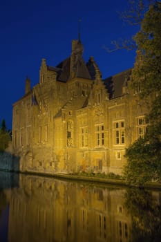 Historic houses along Dijver Canal in Bruges at night. (Belgium)