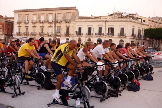 a fitness class in the old town of Siracusa in Sicily in south Italy in Europe.