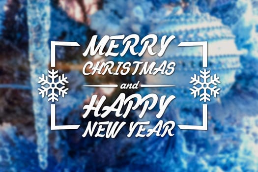Merry Christmas and New Year greeting card on blurred festive decoration ball or toy and spruce blue colored background