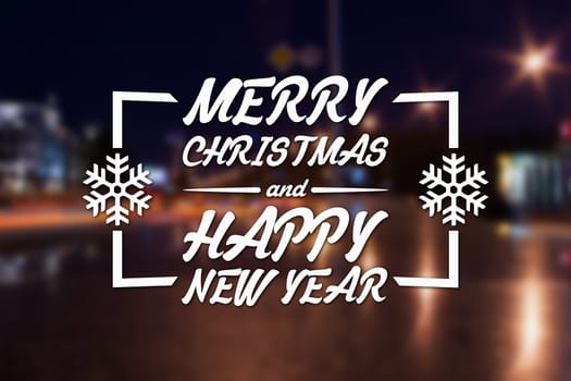 Merry Christmas and New Year greeting card on blurred night city streets illuminated buildings background
