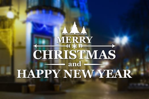 Merry Christmas and New Year greeting card on blurred night city streets illuminated buildings background