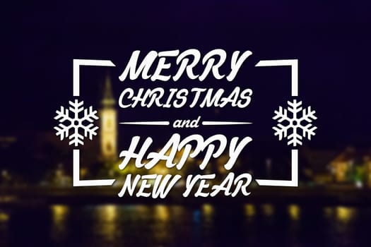 Merry Christmas and New Year greeting card on blurred night city illuminated old buildings with reflection in water background