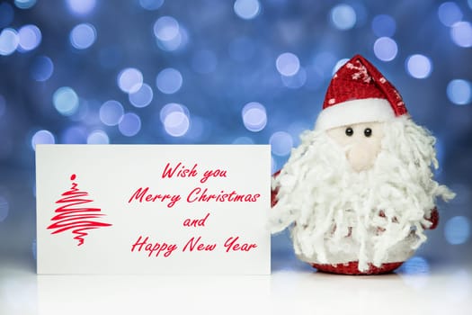 Santa Claus or Father Frost with Christmas greeting card on white surface