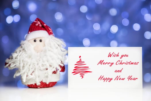 Santa Claus or Father Frost with Christmas greeting card on white surface