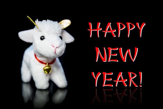 New Year greeting card or postcard with white goat or sheep toy the chinese symbol of 2015 year on black background with reflection