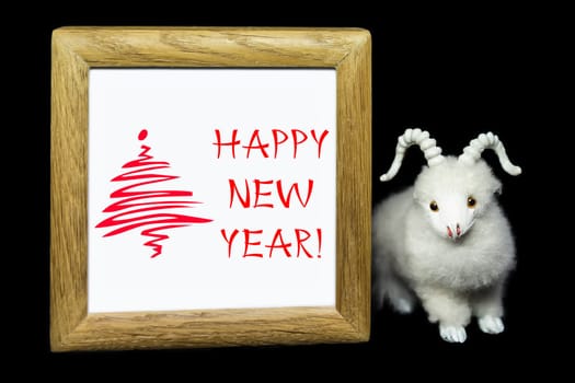 New Year greeting wooden frame with white goat or sheep toy the chinese symbol of 2015 year on black background
